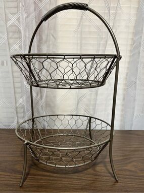 2-tier basket made of metal w/chicken wire design antiqued color. 9” bowls 13”H
